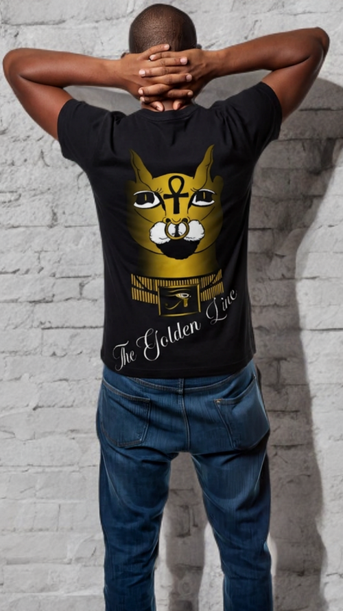 Person wearing a black t-shirt with a graphic design of a cat and text, standing against a light gray brick wall.