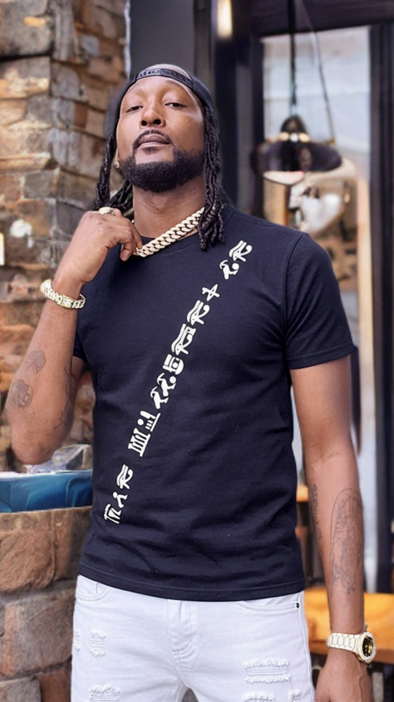 Man wearing a black t-shirt with white graphics in a casual setting