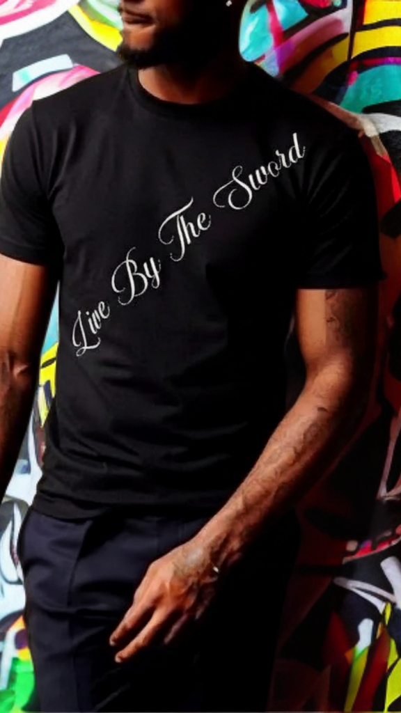 Person wearing a black t-shirt with 'Live By The Sword' text against a colorful graffiti wall.