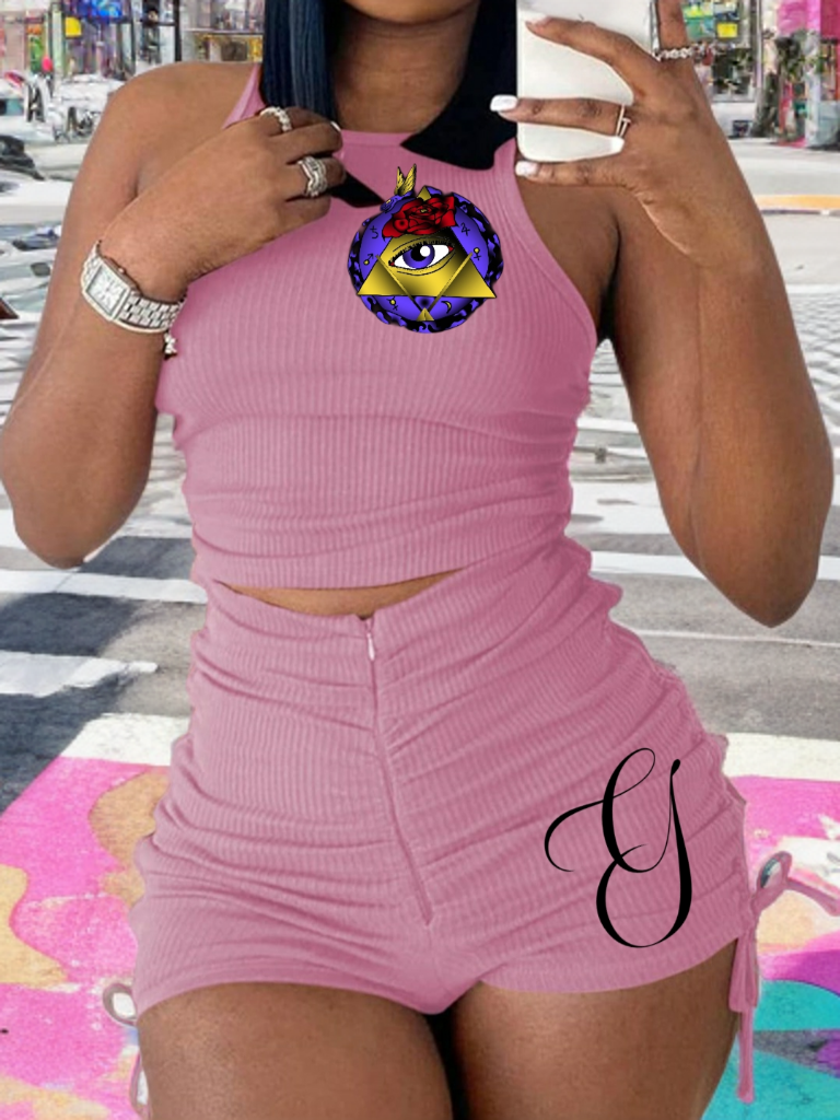 Person wearing a pink outfit with a colorful design on a city street.