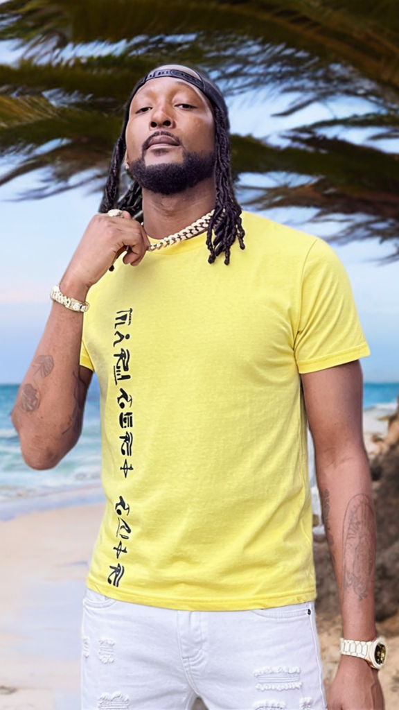 Man wearing a yellow t-shirt with text on a beach
