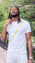 Man wearing a white t-shirt with yellow text outdoors