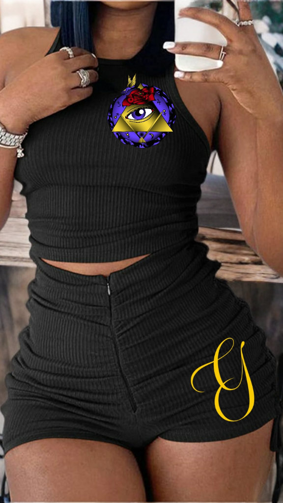 Person wearing a black outfit with a unique design on a blurred background