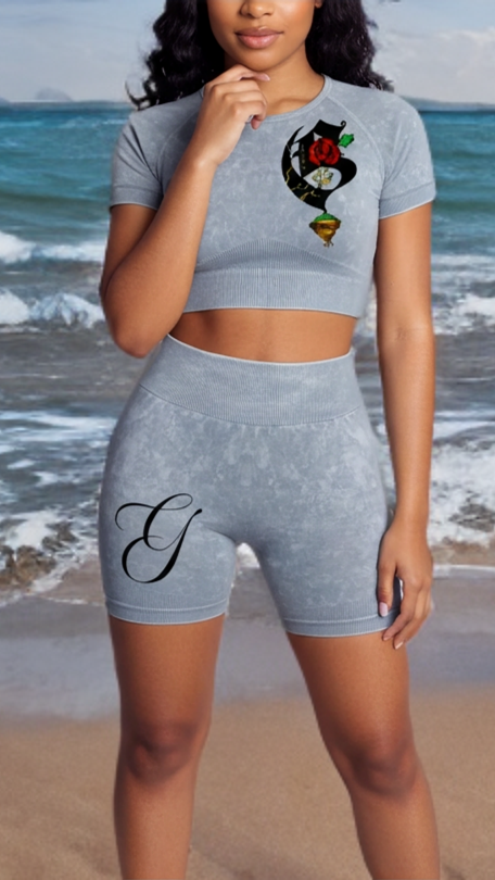 Woman in gray athletic wear with a design on a beach