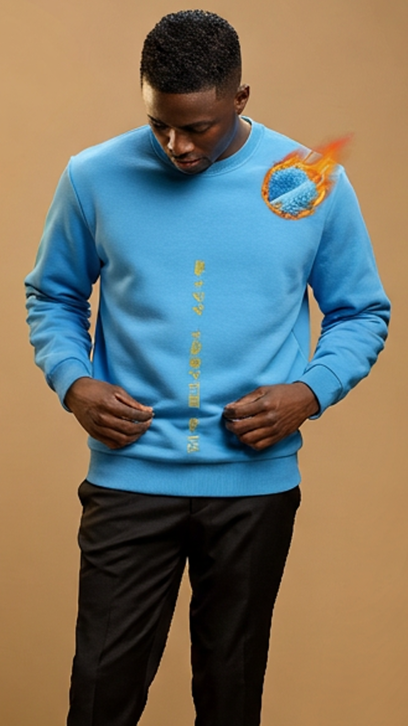 Person wearing a blue sweatshirt with a graphic design on a beige background