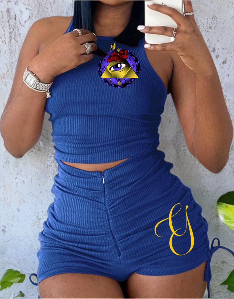 Blue ribbed top and shorts set with a colorful design on a textured wall background