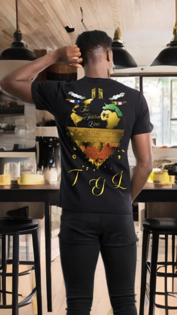 Person wearing a black t-shirt with a colorful design and text in a casual setting.