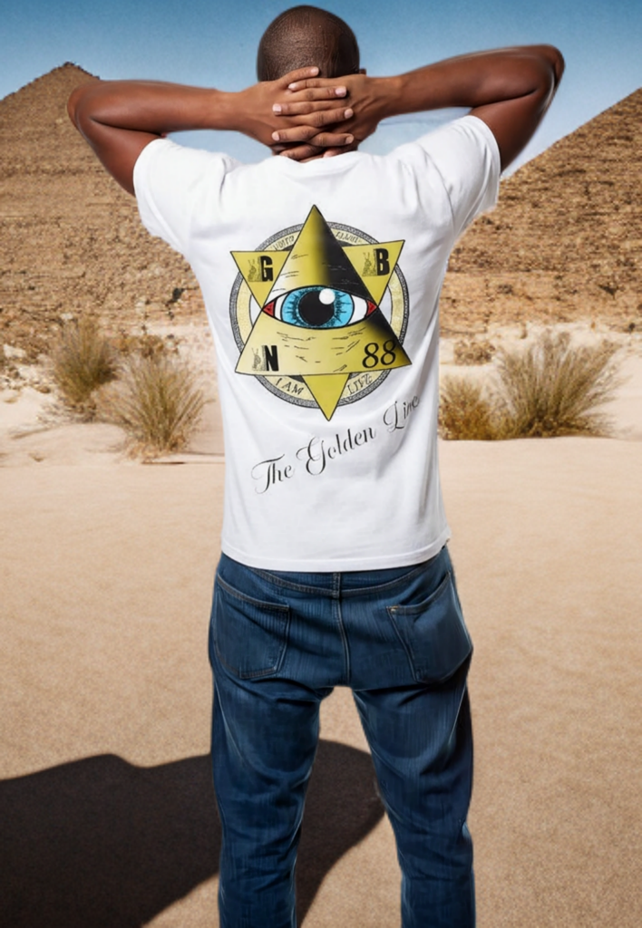 Person wearing a white t-shirt with a pyramid and eye design in the desert.