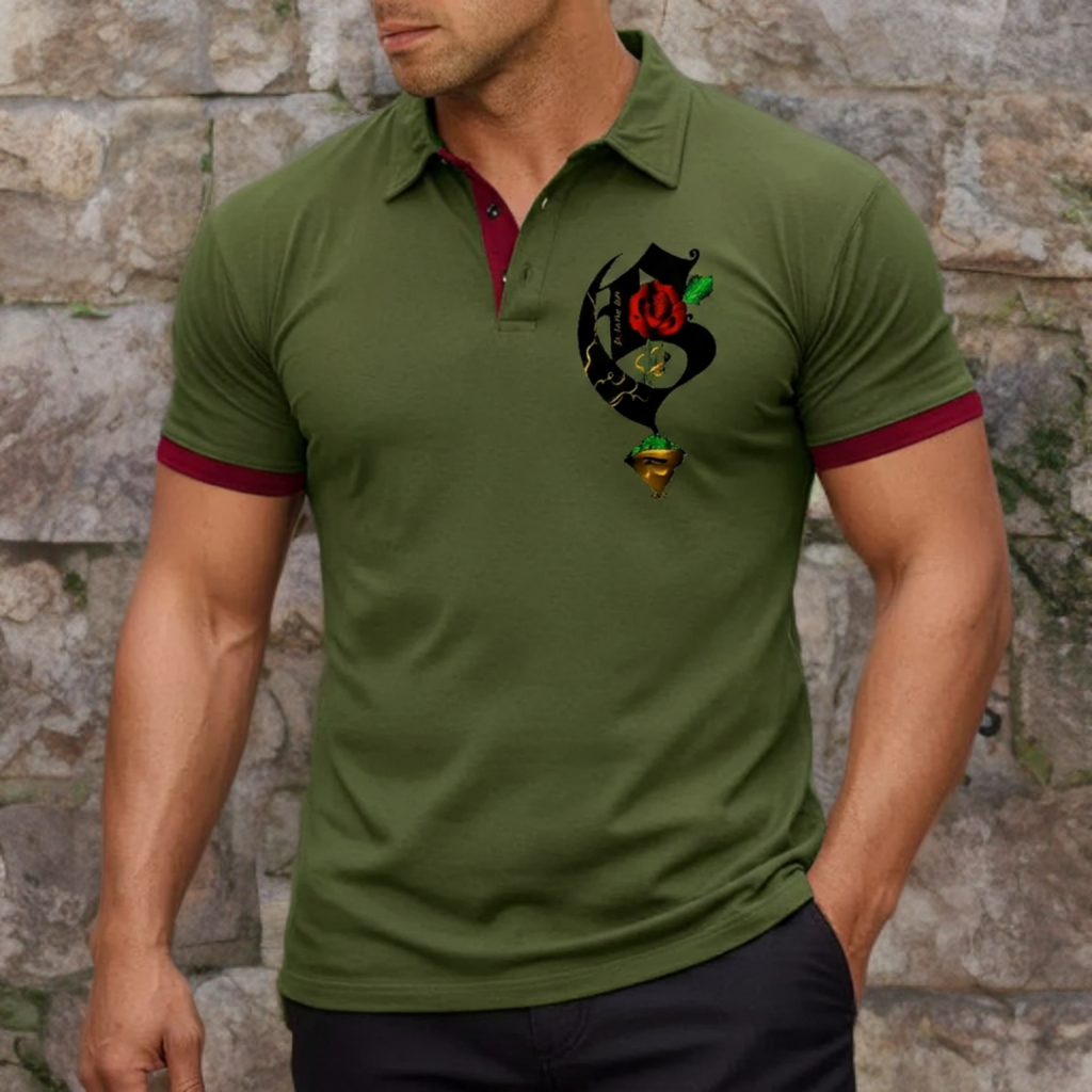 Man wearing a green polo shirt with a colorful design on a stone wall background